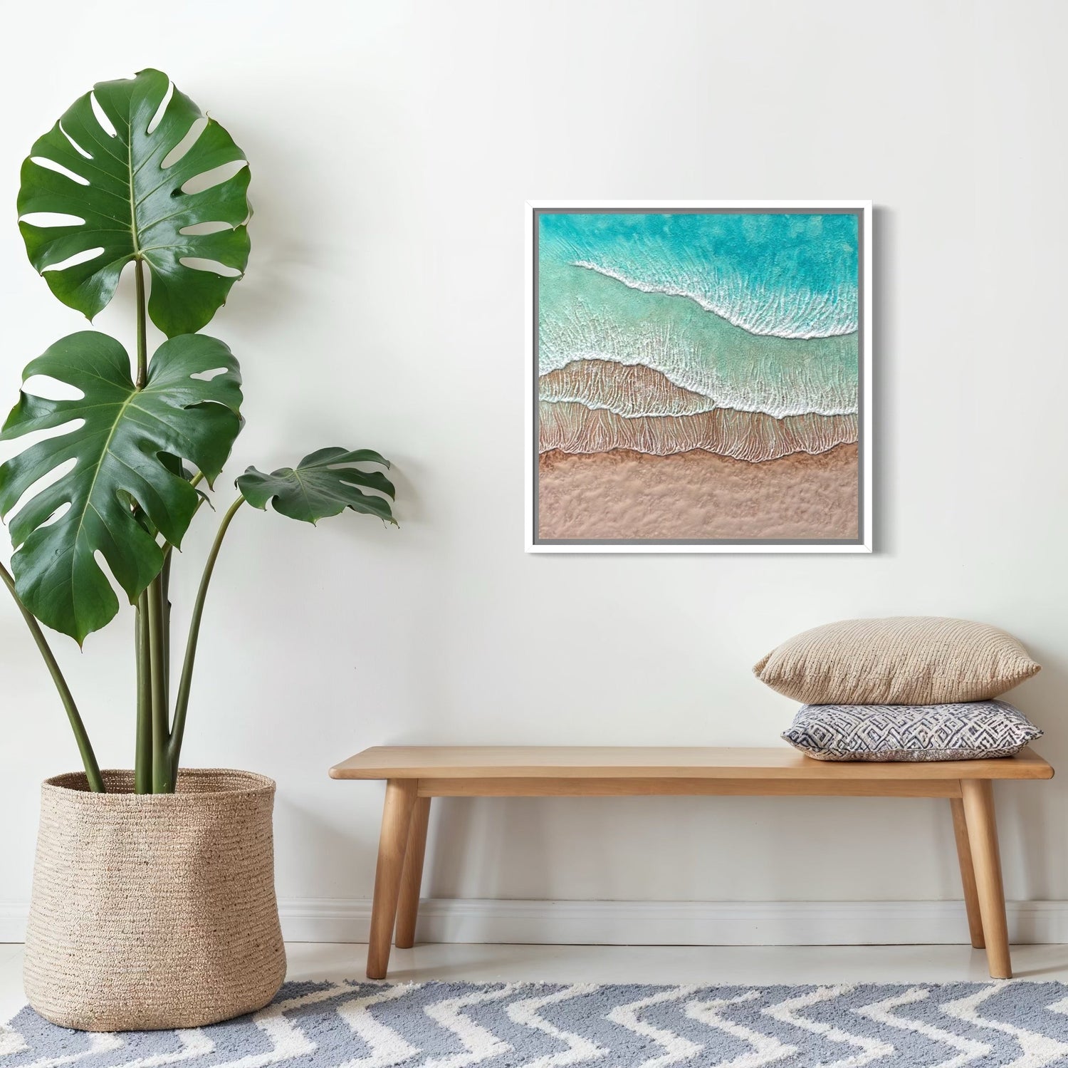 Nest living room with a plant, bench, mirror, and an original Korin Fine Art birds eye view painting on a white wall.